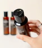 Hand Holding MScents Perfume Collection Essential Purifier Oil Bottle Top Shot