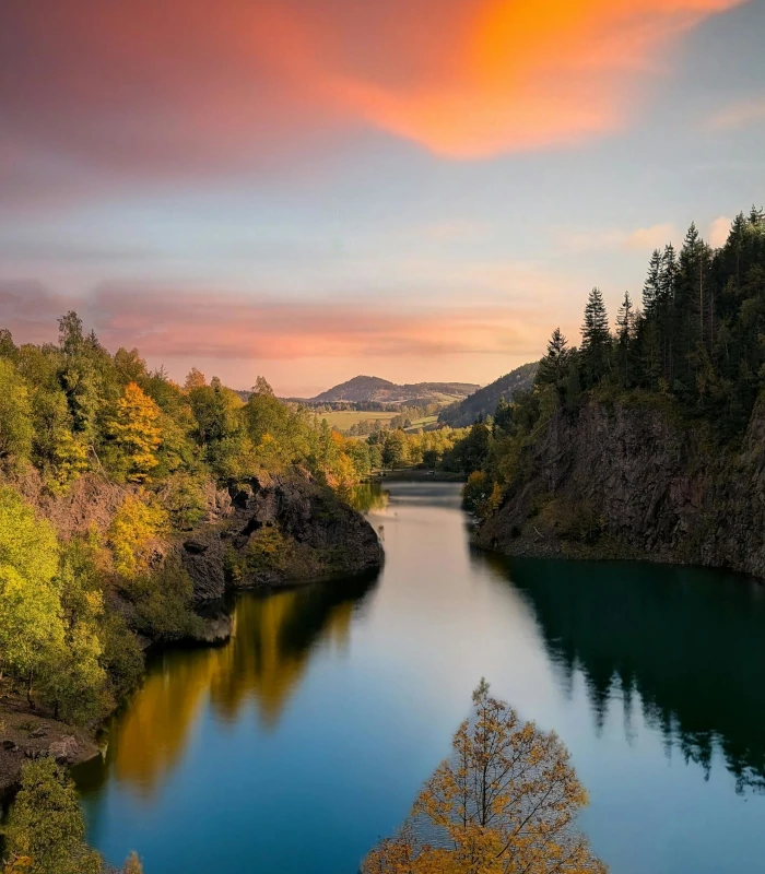 beautiful tranquil lake surrounded by green trees