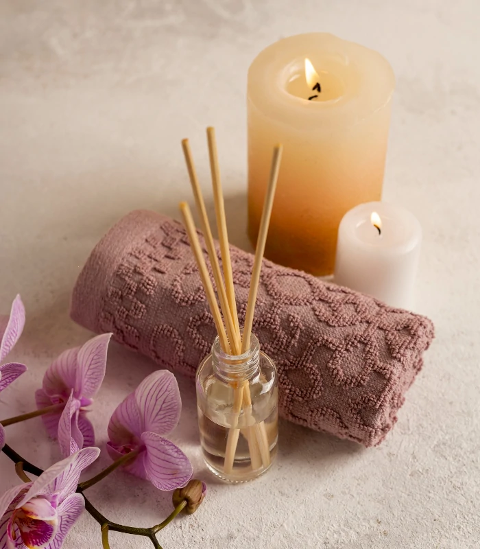 lighted aromatherapy candles and reed diffuser with purple orchid