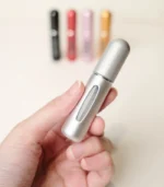 Hand Holding Matte Silver MScents Travel Perfume Atomiser Close Up