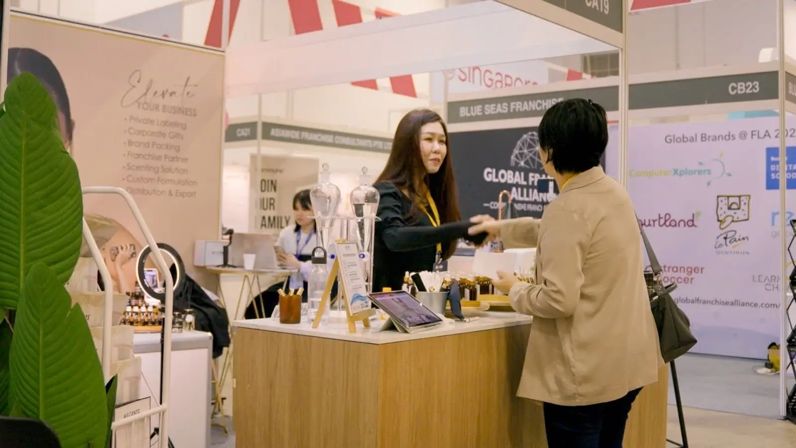 Female MScents sales specialist shaking hands with customer