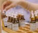 scent marketing singapore: A woman's hand handling mini scent bottles