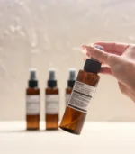 Hand holding MScents mosquito repellent bottle