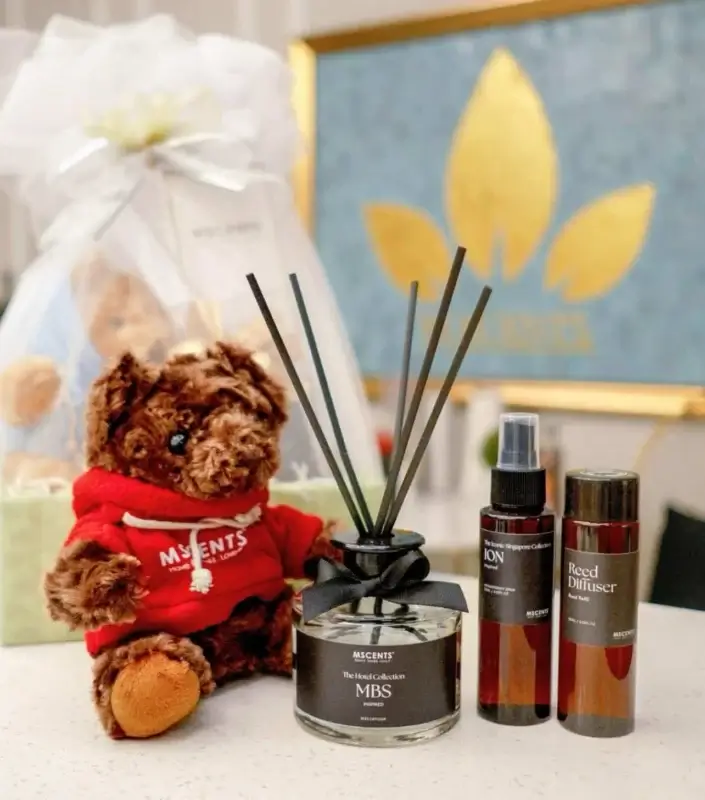MScents luxury hotel and iconic Singapore reed diffusers posed with teddy bear