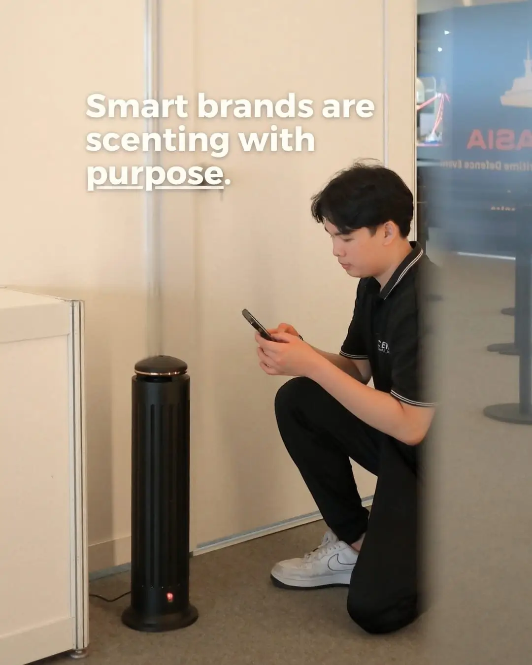 Male MScents staff sets up scent diffuser in a public space
