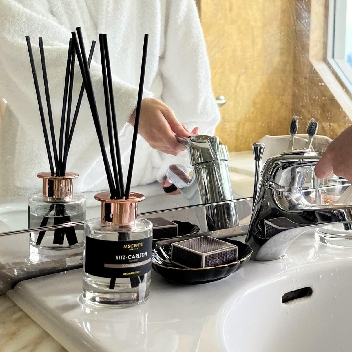 A woman in the hotel bathroom in front of a diffuser
