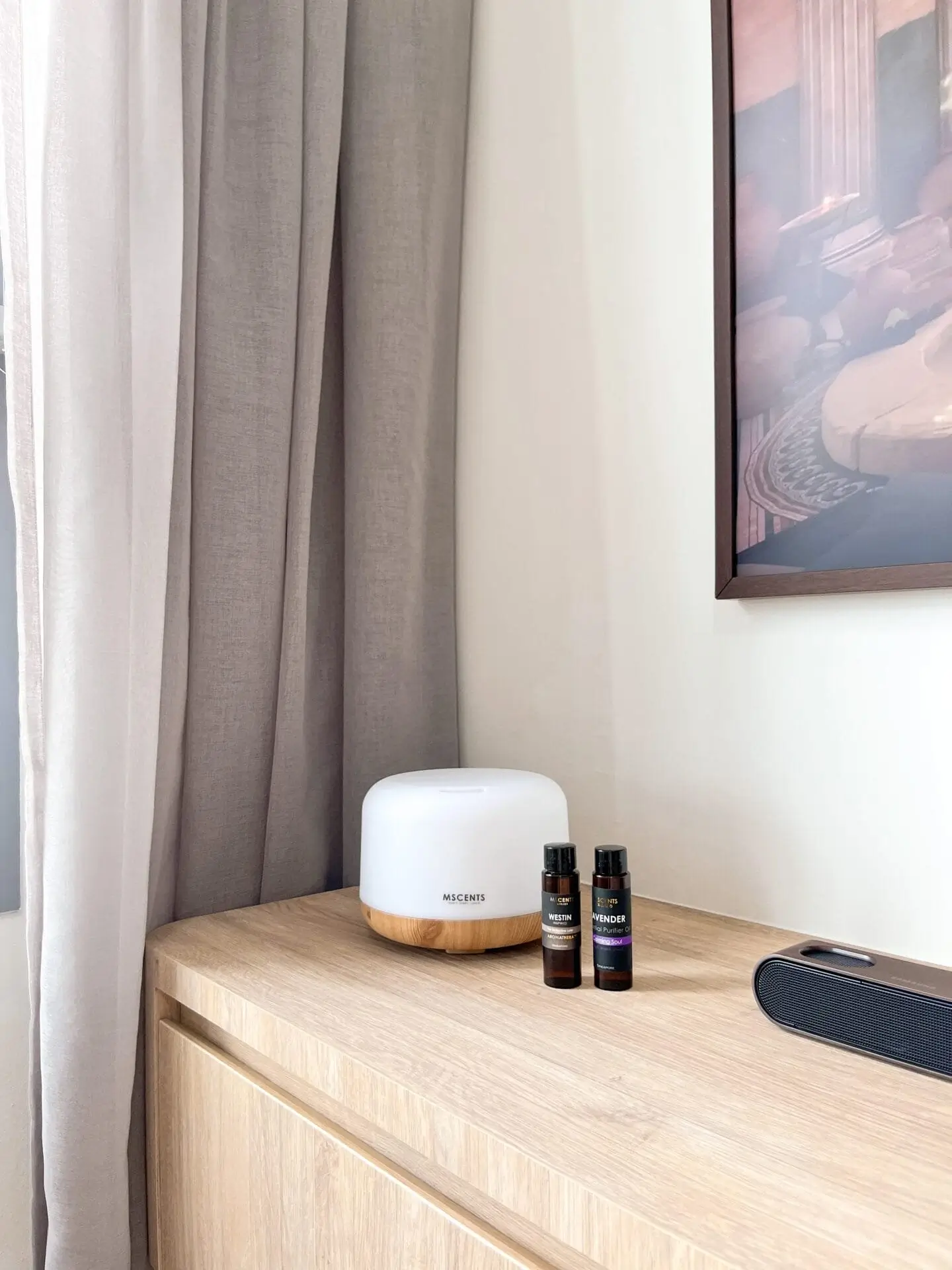 Two bottles of MScents fragrance beside aroma diffuser on table
