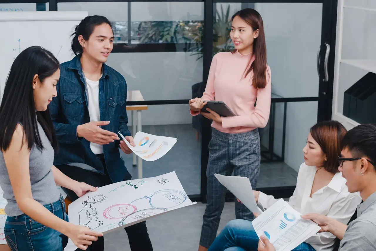 a group of young people discussing brainstorming ideas