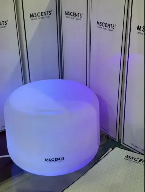 White MScents diffuser beside white boxes of other products