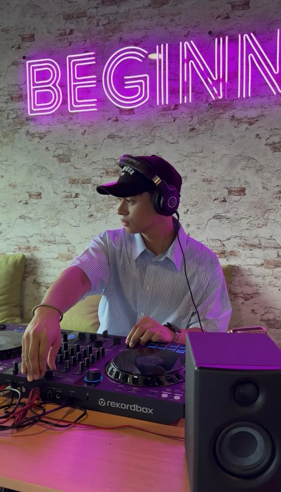 A professional DJ working in the DJ booth at an event