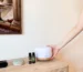 A-hand-placing-a-scent-diffuser-on-top-of-a-room-table